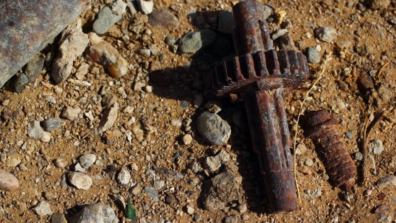 Close-up photo of a rusty screw and cog in the Kyzyl Kum.