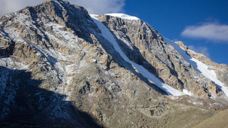 The north side of Munghulik Mountain in Tuva with an icy, snow-filled gully in the middle face.