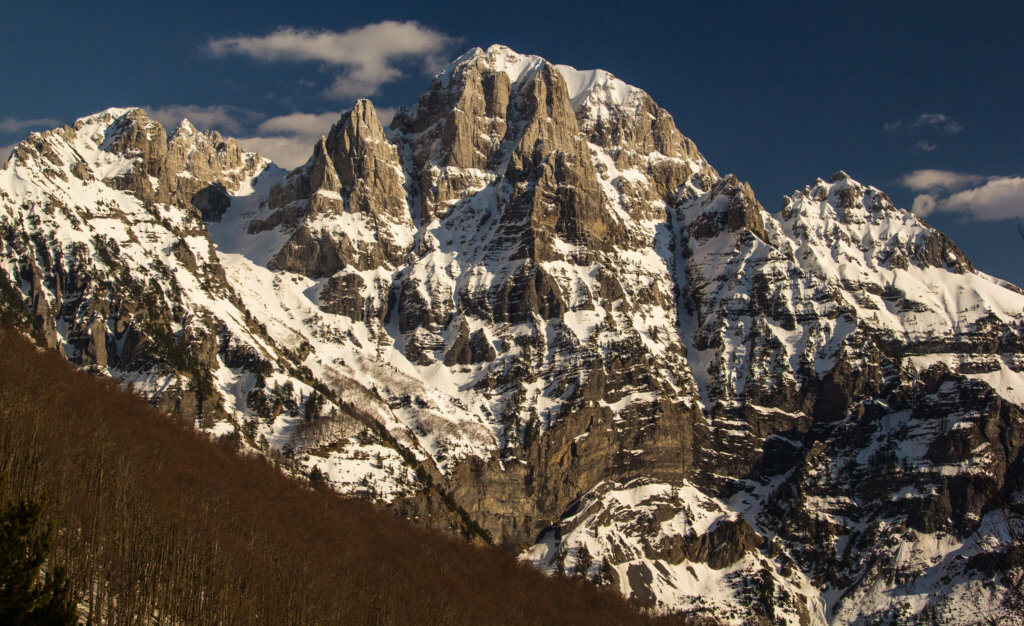 Very big limestone mountain with snow-filled gullies.