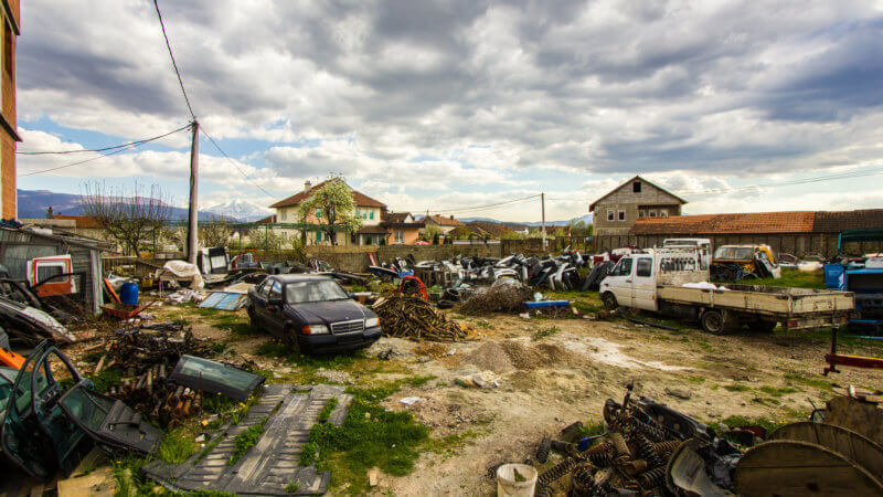 A yard in Kosovo filled with abandoned cars.