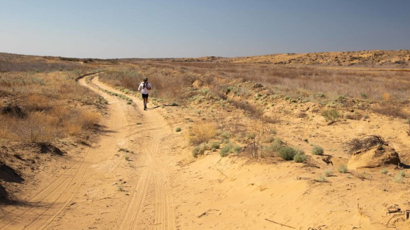 Jamie Maddison running in the Saryesik Atyrau desert on a 35°C+ day in southern Kazakhstan.