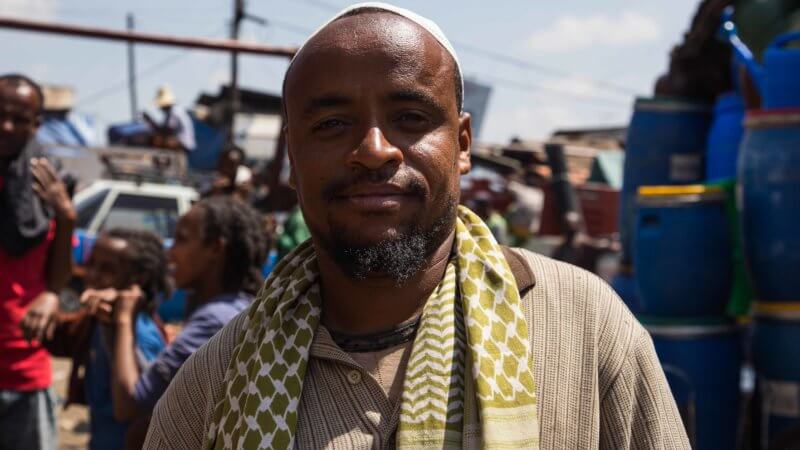 Portrait of Muslim man with green scarf and short beard in Addis Ababa.
