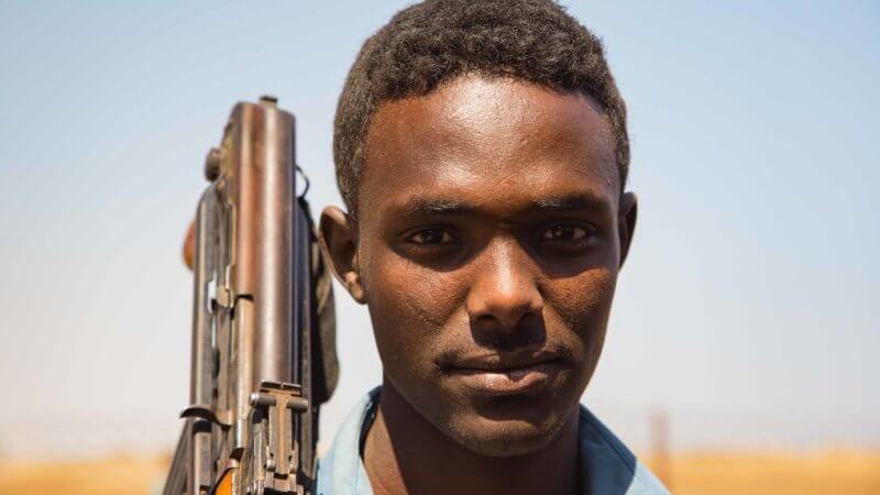 A portrait of Afar policeman with gun over his shoulder.