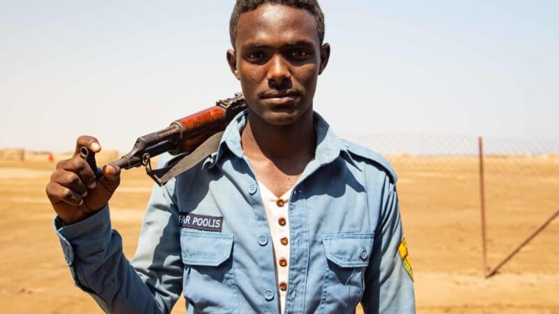 A young Afar policeman with his AK-47 slung over his shoulder.