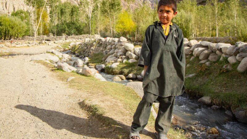 Photo of Wakhan Corridor kid wearing green outfit,