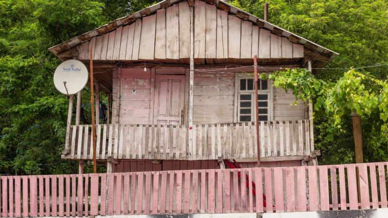 A pastel pink two-floored wooden hut in southern Georgia.